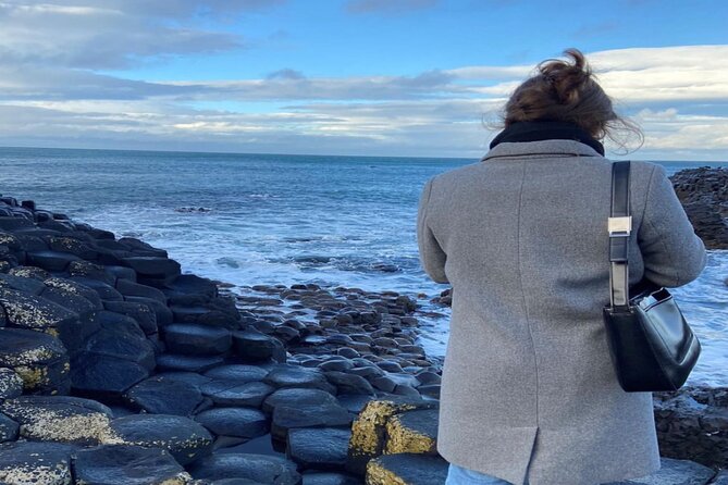 Giants Causeway, Rope Bridge, Carrickfergus Castle and Dark Hedges Tour - Dunluce Castle, cliffs, and changing daylight