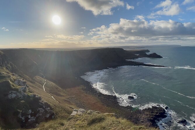 Private Belfast Mural & Giant's Causeway Tour from Belfast (2 in 1) - Dunluce Castle, Ballintoy Harbour, and the Dark Hedges